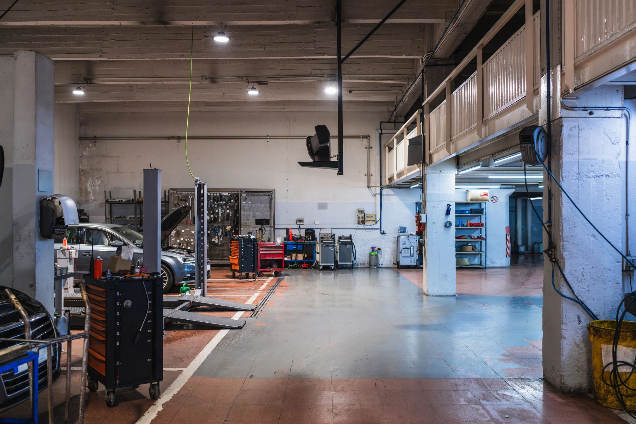 Clean automotive service bay with vehicle lifts and tools