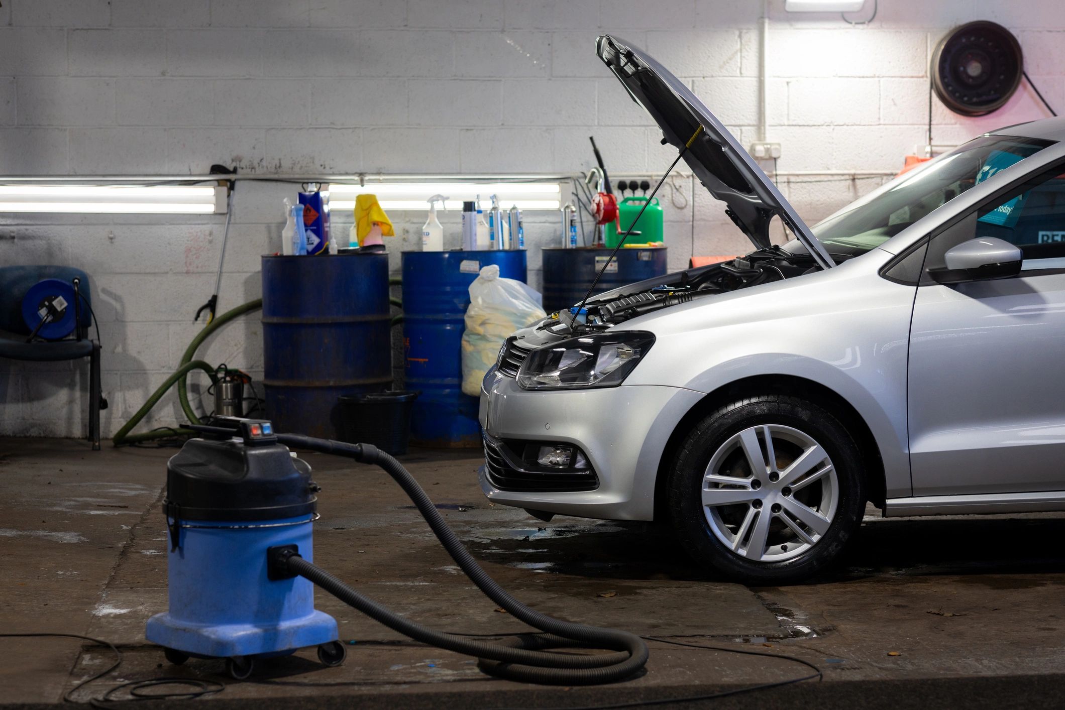 Vehicle being serviced inside an automotive shop
