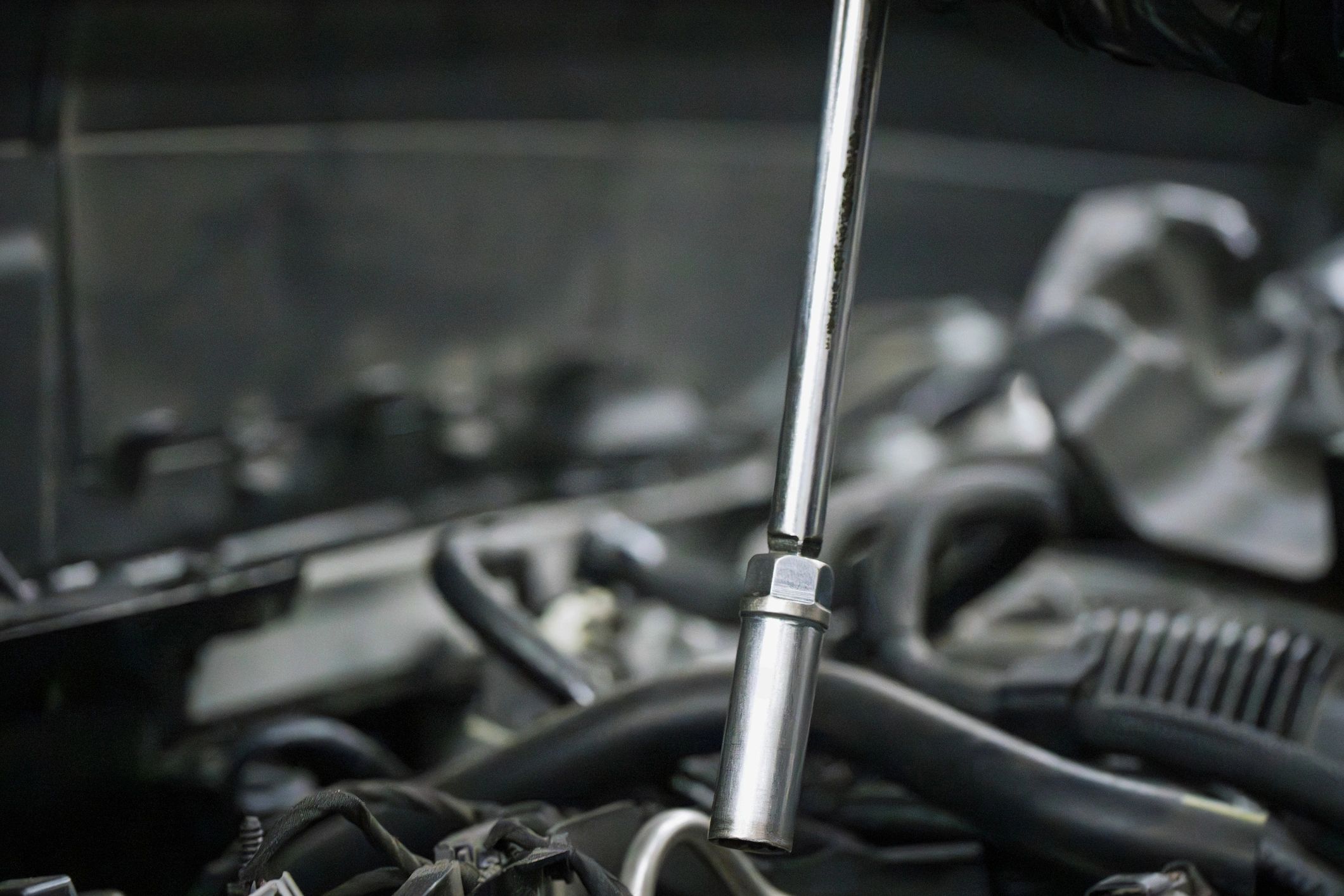 Automotive repair work being performed with a socket wrench